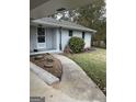 Inviting front entrance with a curved walkway and charming garden details at 105 Tranquility Dr, Villa Rica, GA 30180