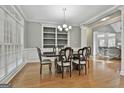 Formal dining room with hardwood floors and a built-in bookshelf at 684 Brooks Woolsey Rd, Brooks, GA 30205