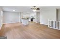 Open floor plan showcases a spacious living area flowing into a kitchen with white cabinetry and hardwood floors at 4239 Newcomb Rd, Decatur, GA 30034