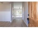 Inviting entryway with hardwood floors, light gray walls, white trim, and a glimpse of the bright living space at 152 Wet Wood Dr # 10, Fairburn, GA 30213
