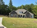 Craftsman style home boasts stone accents, inviting front porch and expansive front lawn at 152 Wet Wood Dr # 10, Fairburn, GA 30213