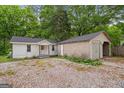View of backyard featuring the house and a detached garage at 734 W College St, Bowdon, GA 30108