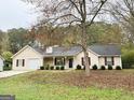 Charming home featuring manicured landscaping, a covered front porch, and a well-maintained lawn at 130 Nicki Ct, Hampton, GA 30228