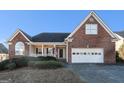 Inviting brick home featuring a covered porch and two-car garage at 625 Aya Cir, Loganville, GA 30052