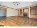 Bright and airy living room features hardwood floors, a fireplace, and built-in shelving at 625 Aya Cir, Loganville, GA 30052
