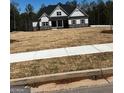 New construction home featuring stone accents and a well-manicured lawn in a suburban community at 5480 Two Hills Dr # 31, Fairburn, GA 30213