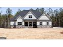 Charming home showcasing gray siding, stone accents, and a welcoming front porch at 5480 Two Hills Dr # 31, Fairburn, GA 30213