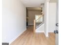 Inviting foyer with hardwood floors, staircase, and stone fireplace in the living room at 5480 Two Hills Dr # 31, Fairburn, GA 30213