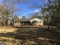 Traditional brick ranch home with shutters and covered front porch at 55 Gill Ln, Stockbridge, GA 30281