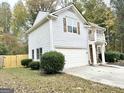 Two-story house with gray siding, stone accents, and a two-car garage at 3560 Butler Springs Nw Trce, Kennesaw, GA 30144