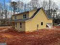 Rear view of new construction home highlighting its design and features at 1563 South Bethany Rd, Mcdonough, GA 30252