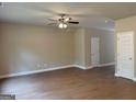 Spacious living room with wood floors, neutral walls, and ceiling fan at 1555 South Bethany Rd, Locust Grove, GA 30248