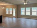 Open concept living space with lots of natural light, wood floors, and neutral walls at 1555 South Bethany Rd, Locust Grove, GA 30248