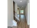 Hallway with wood-look floors that seamlessly connect the living spaces of the home at 1547 South Bethany Rd, Locust Grove, GA 30248