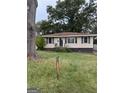 Cute single story home with manicured lawn and large shade trees at 1511 Walker Ave, College Park, GA 30337