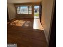 Inviting living room with gleaming hardwood floors and sun-drenched bay window at 1511 Walker Ave, College Park, GA 30337