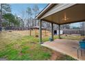 Expansive backyard featuring a covered patio, gazebo, and plenty of green space for outdoor activities at 1406 Stone Ridge Ct, Hampton, GA 30228