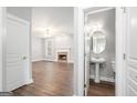Well-lit bathroom featuring a pedestal sink and tile floors, situated near an adjacent living space at 1714 Boulder Walk Se Ln, Atlanta, GA 30316