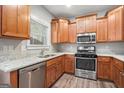 Modern kitchen featuring granite countertops, stainless steel appliances, and wood cabinets at 1714 Boulder Walk Se Ln, Atlanta, GA 30316