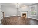 Bright living room featuring hardwood floors, a classic fireplace, and large windows at 1714 Boulder Walk Se Ln, Atlanta, GA 30316