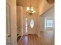 Bright foyer with gleaming hardwood floors, chandelier, and a view into the adjacent living spaces at 4284 Caroline Ct, Douglasville, GA 30135