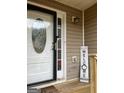 Close up of the front door with sidelight, welcome sign, and freshly painted trim at 4284 Caroline Ct, Douglasville, GA 30135