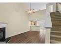Open-concept living room with hardwood floors, fireplace, and a view into the kitchen at 167 London Dr, Mcdonough, GA 30253