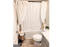 Cozy bathroom featuring a shower with a white curtain and light gray cabinets at 116 Jodi Pl, Locust Grove, GA 30248