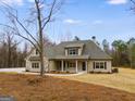 Charming single Gathering home featuring stone accents, neutral color palette, and inviting covered front porch at 426 Ayers Rd, Bowdon, GA 30108