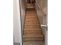 Unfinished staircase featuring plywood and a natural wood railing at 1601 Celestial Ct, Mcdonough, GA 30253