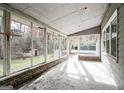 Enclosed sunroom featuring brick base and multiple windows offering a scenic view of the backyard at 849 Wagon Wheel Cir, Fayetteville, GA 30214