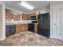 Efficient kitchen with wooden cabinets, modern appliances, and durable tile flooring creating a functional cooking space at 5828 Union Walk Dr, Union City, GA 30291