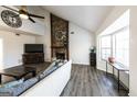 Bright living room features a stone fireplace, large windows, and hardwood floors at 5479 Dorsett Shoals Rd, Douglasville, GA 30135