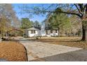 Ranch home with long driveway and mature trees at 32 Collins Rd, Locust Grove, GA 30248