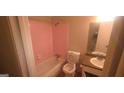 Bathroom featuring a shower-tub combo with pink tile and a granite-look vanity at 3603 Manhattan Dr, Decatur, GA 30034