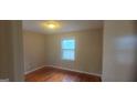 This bedroom features wood floors, neutral colored walls and a window for natural light at 3603 Manhattan Dr, Decatur, GA 30034