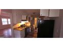 Kitchen with light countertops, white upper cabinets, and black appliances at 3603 Manhattan Dr, Decatur, GA 30034