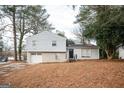 Updated exterior of a charming house with a gray siding and brick detailing at 8816 Ashwood Dr, Riverdale, GA 30274