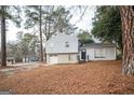 Updated exterior of a charming house with a gray siding and brick detailing at 8816 Ashwood Dr, Riverdale, GA 30274