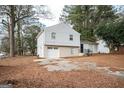 Updated exterior of a charming house with a gray siding and brick detailing at 8816 Ashwood Dr, Riverdale, GA 30274