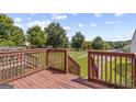 Wooden deck overlooking a fenced backyard with green lawn at 103 Odyssey Turn, Conyers, GA 30012