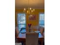 Formal dining room featuring a chandelier and plenty of natural light at 3722 Lockerbie Ln, Powder Springs, GA 30127