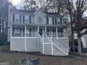 Two story home with dark shutters, white porch, and stairs leading to the front door at 3722 Lockerbie Ln, Powder Springs, GA 30127