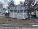 Two story home with a dark roof, porch, white stairs, and dark shutters at 3722 Lockerbie Ln, Powder Springs, GA 30127