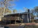 Charming single story home featuring a front deck, landscaped yard, and inviting entrance at 2020 Moore Rd, Moreland, GA 30259