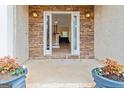 Inviting entryway with stone accents, featuring an open door and planters on either side, welcoming guests at 232 Terrane Rdg, Peachtree City, GA 30269