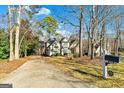 Charming home featuring a well-maintained lawn, long driveway, and mailbox with the house number displayed at 232 Terrane Rdg, Peachtree City, GA 30269