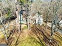 Traditional home with a neutral color scheme, surrounded by mature trees, and a green lawn at 232 Terrane Rdg, Peachtree City, GA 30269