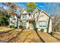 Two-story house with green accents and a stone facade at 232 Terrane Rdg, Peachtree City, GA 30269