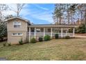 Charming home featuring a covered carport and inviting front porch at 3435 Misty Valley Rd, Decatur, GA 30032